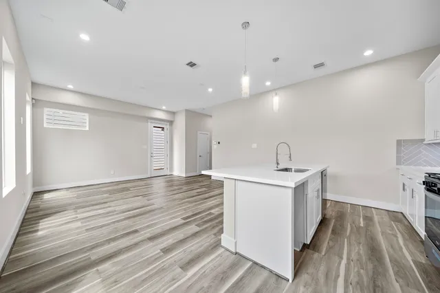 a view of storage and utility room with wooden floor