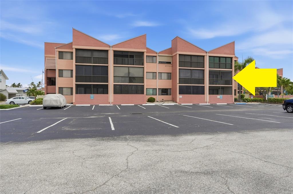 a front view of a building with a parking space and windows