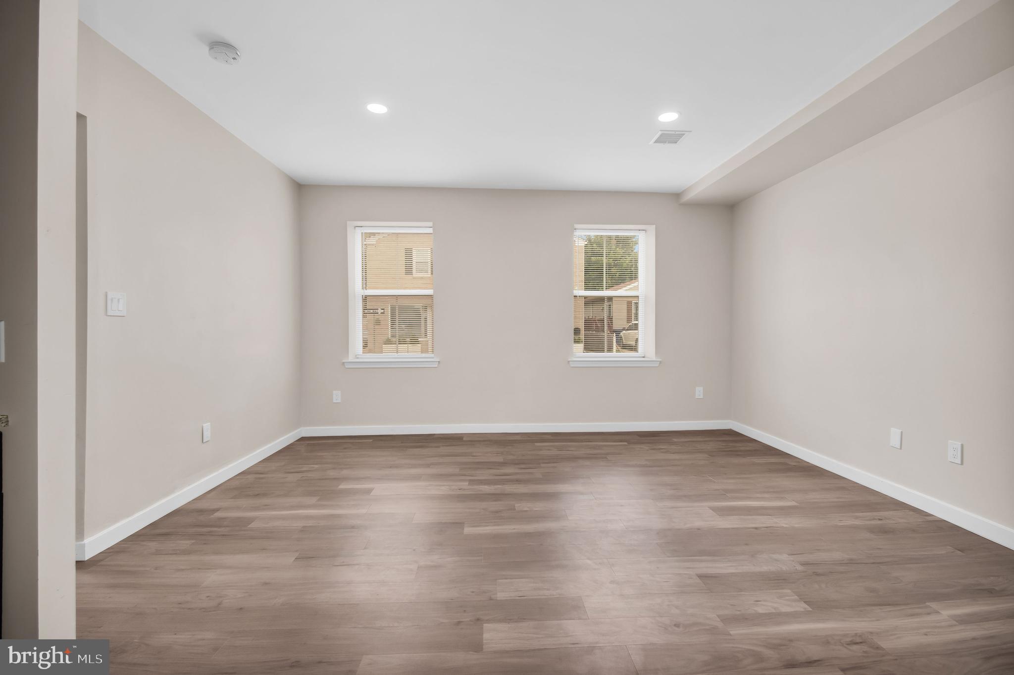 202 Foundry Street Florence, NJ 08518 - Photo 11 of 22 an empty room with wooden floor and windows
