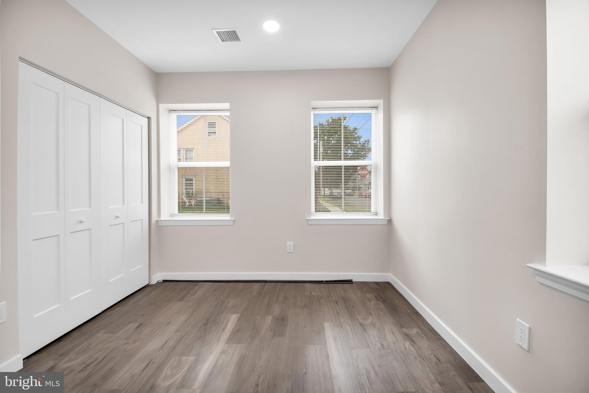 202 Foundry Street Florence, NJ 08518 - Photo 14 of 22 an empty room with wooden floor and windows