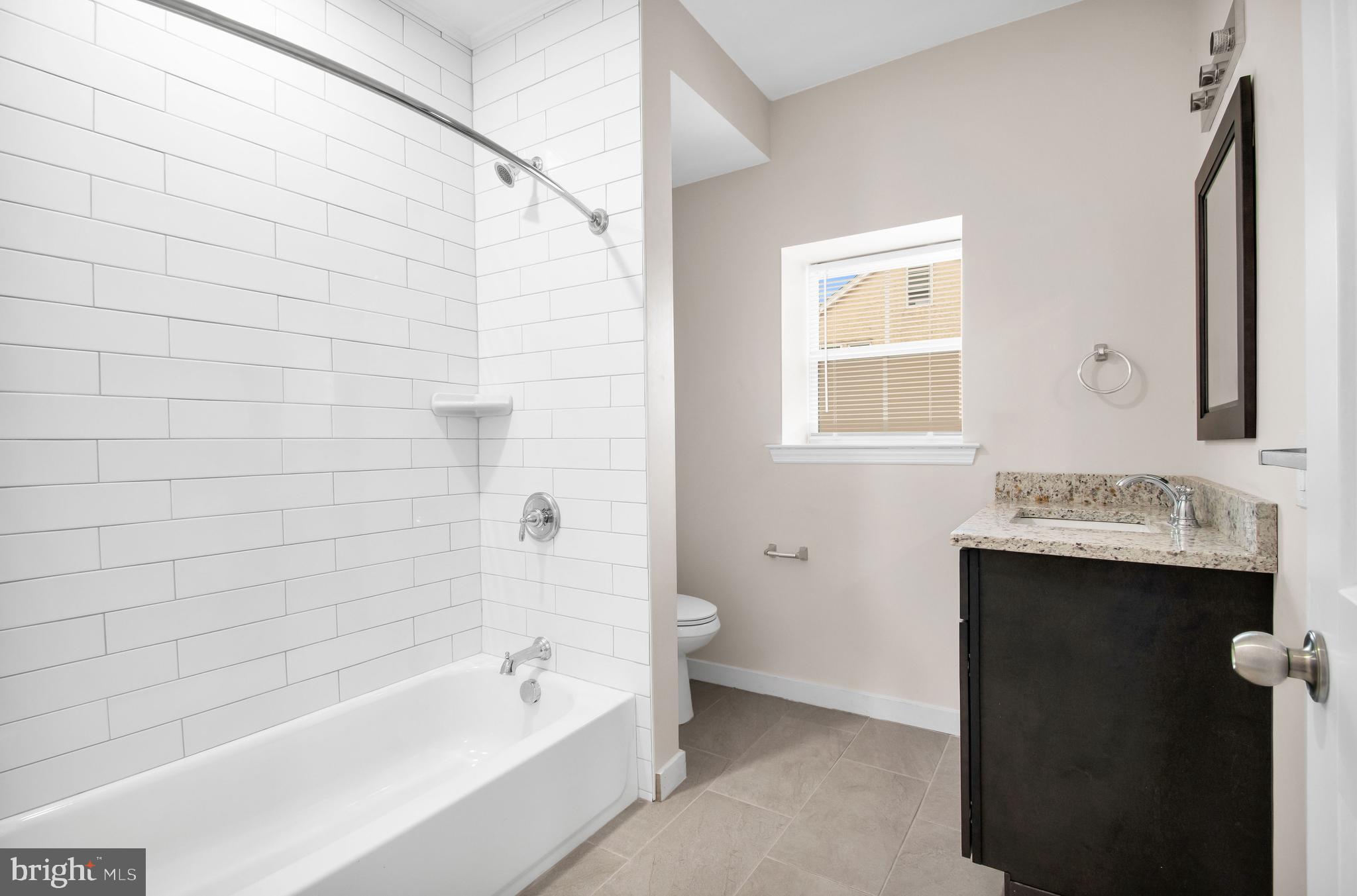 202 Foundry Street Florence, NJ 08518 - Photo 16 of 22 a bathroom with a sink and mirror with bathtub