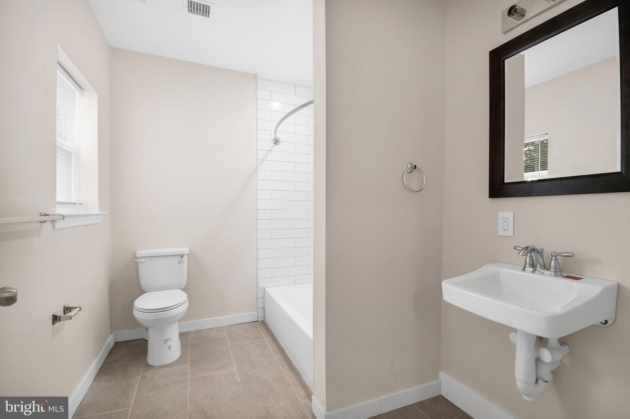202 Foundry Street Florence, NJ 08518 - Photo 17 of 22 a bathroom with a toilet sink and mirror