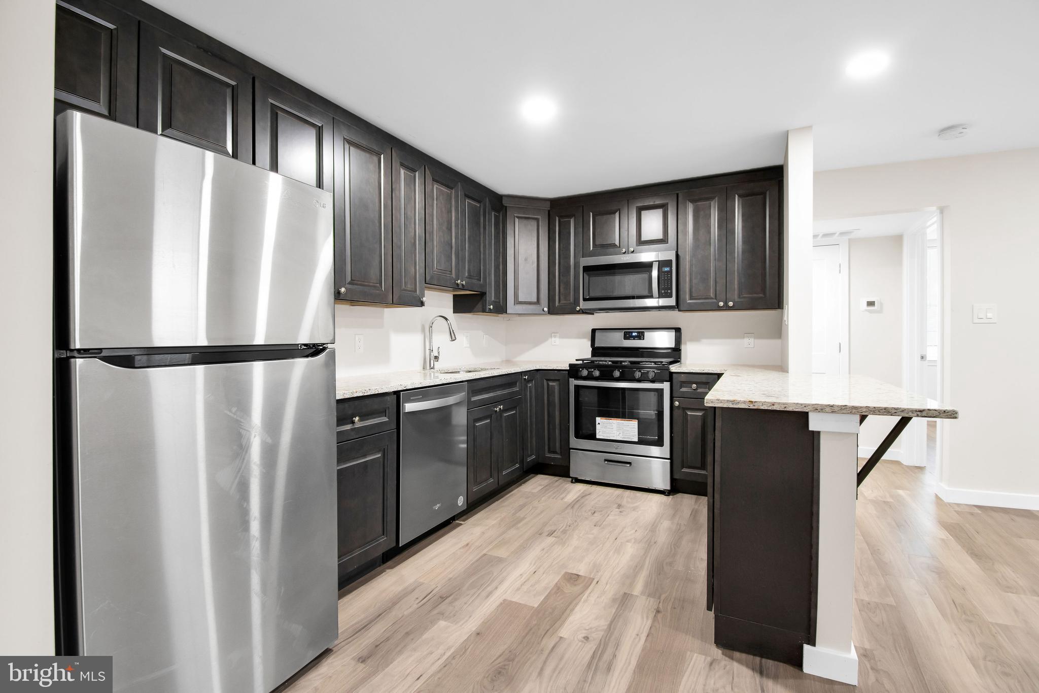 202 Foundry Street Florence, NJ 08518 - Photo 21 of 22 a kitchen with granite countertop stainless steel appliances and wooden cabinets