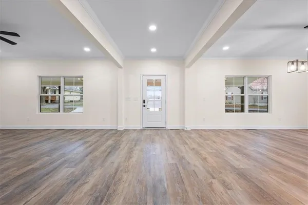 a kitchen with a sink window and cabinets