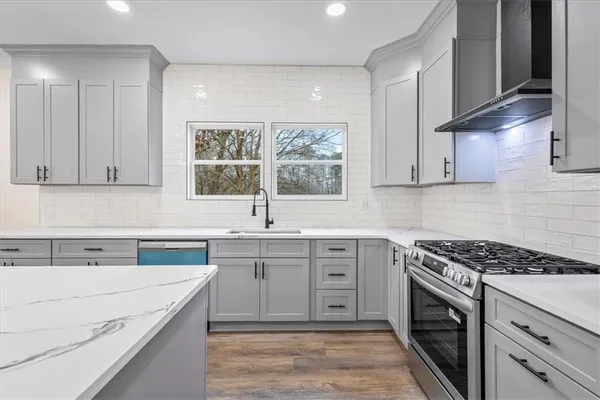 a large kitchen with kitchen island a sink stainless steel appliances and cabinets