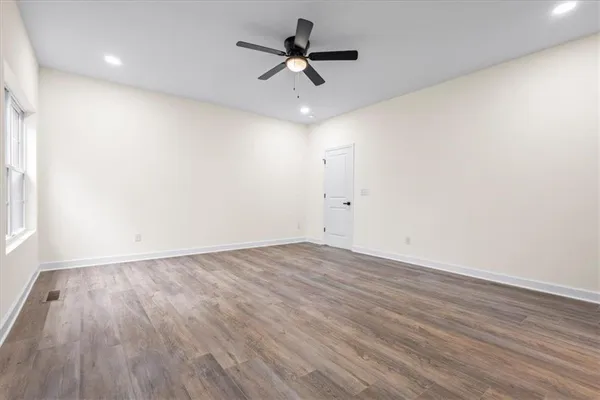 a spacious bathroom with a shower sink and mirror