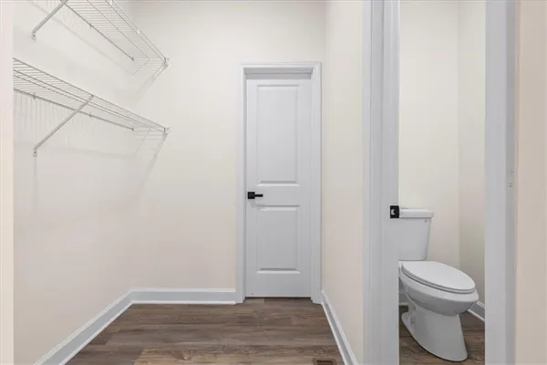 a view of walk in closet with empty racks