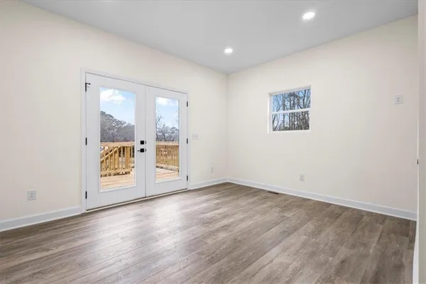 a view of an empty room with wooden floor