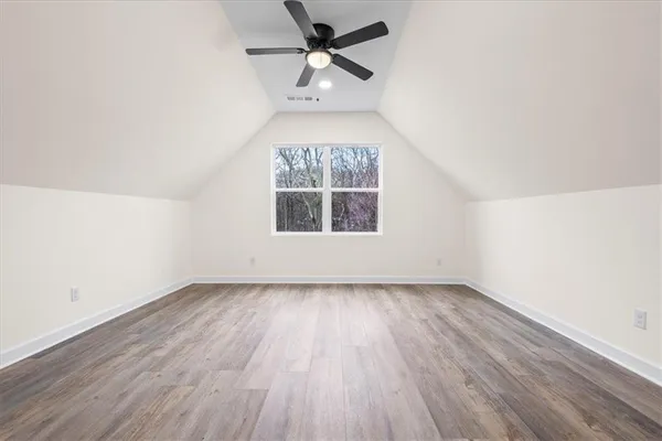 a view of a room with wooden floor and white walls