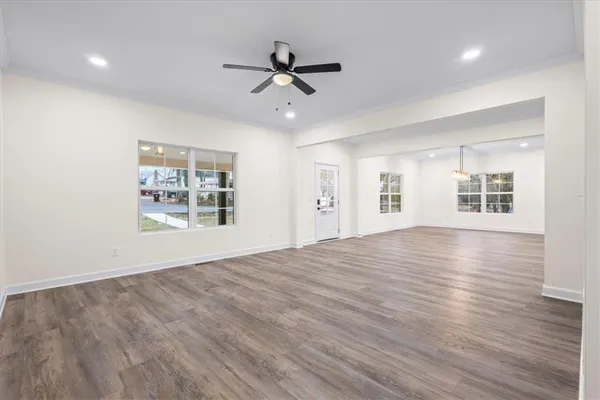 a kitchen with wooden floor window and refrigerator