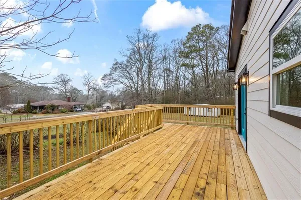 a view of balcony with two chairs and wooden floor
