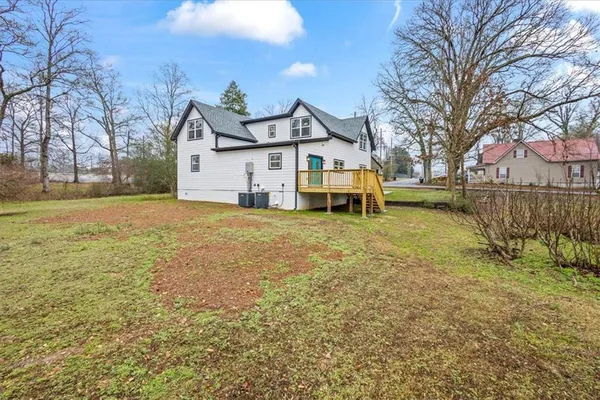 a view of yard with trees and houses in the background