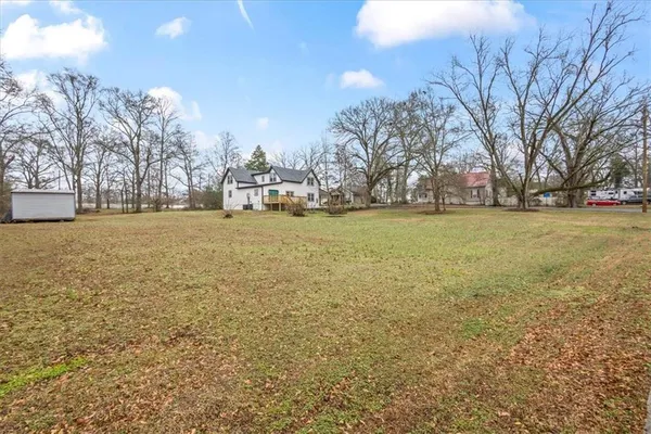 a view of yard with tree in the background