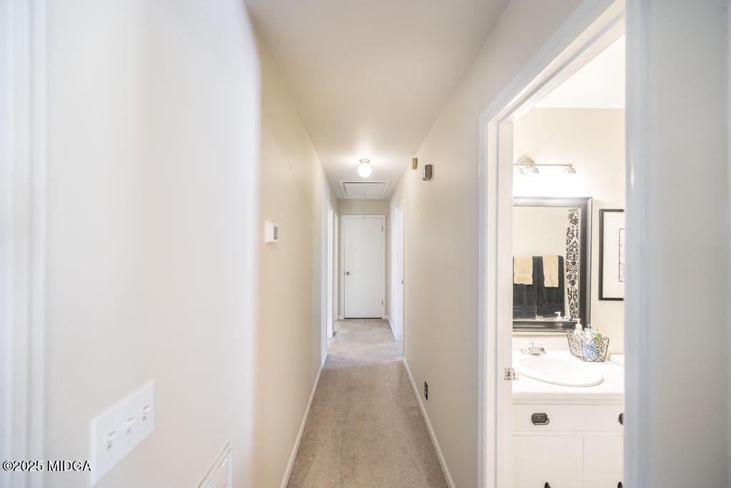 559 Stone Edge Road Macon, GA 31210 - Photo 21 of 40 a view of a hallway with wooden floor