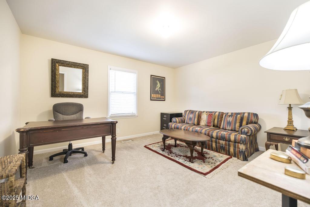 559 Stone Edge Road Macon, GA 31210 - Photo 25 of 40 a living room with furniture and a wooden floor