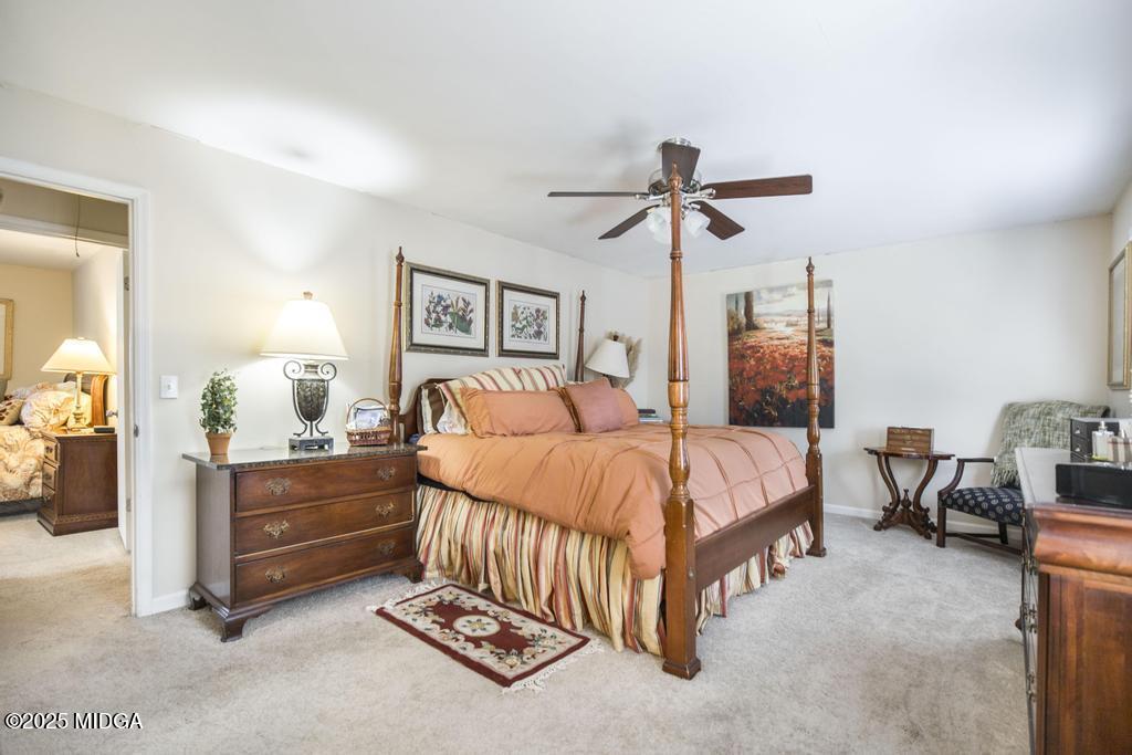 559 Stone Edge Road Macon, GA 31210 - Photo 28 of 40 a bedroom with a bed and a chandelier