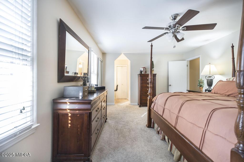 559 Stone Edge Road Macon, GA 31210 - Photo 29 of 40 a bedroom with a bed a window and a chandelier