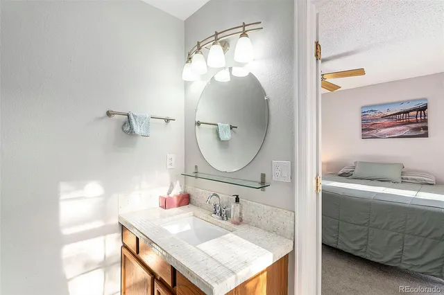 a bathroom with a sink vanity and a mirror