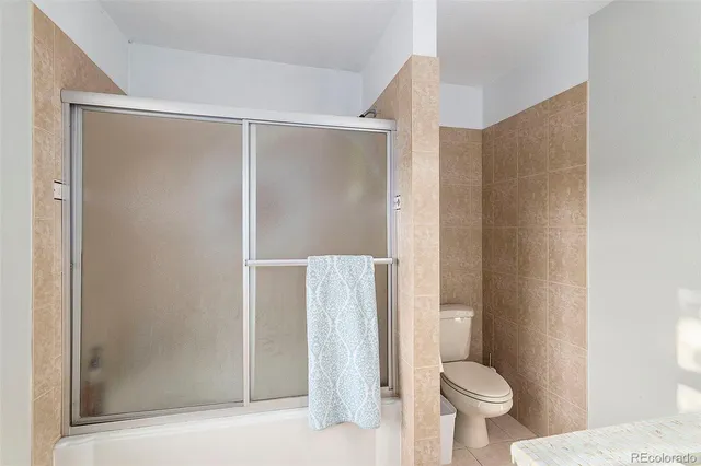 a bathroom with a shower and a toilet