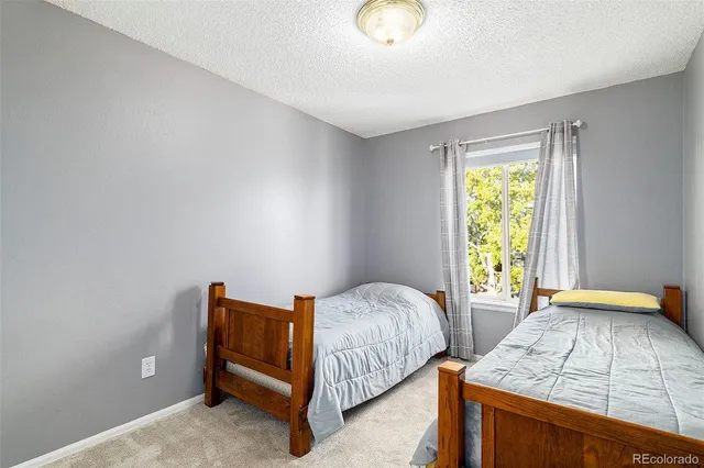 a bedroom with bed and window