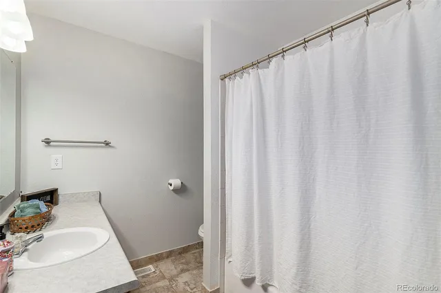 a bathroom with a sink and curtain