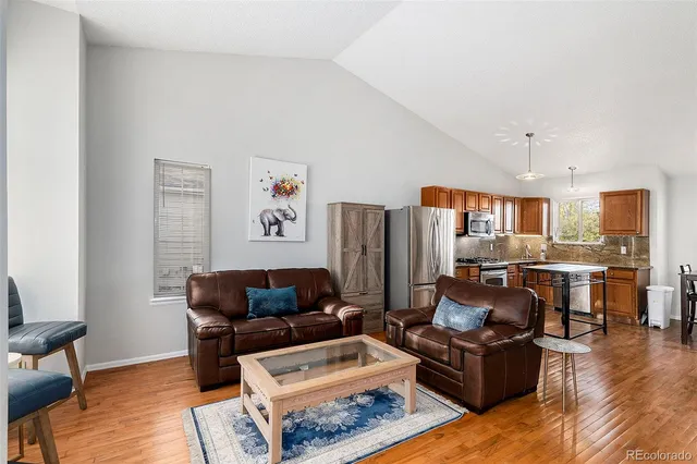 a living room with furniture and wooden floor