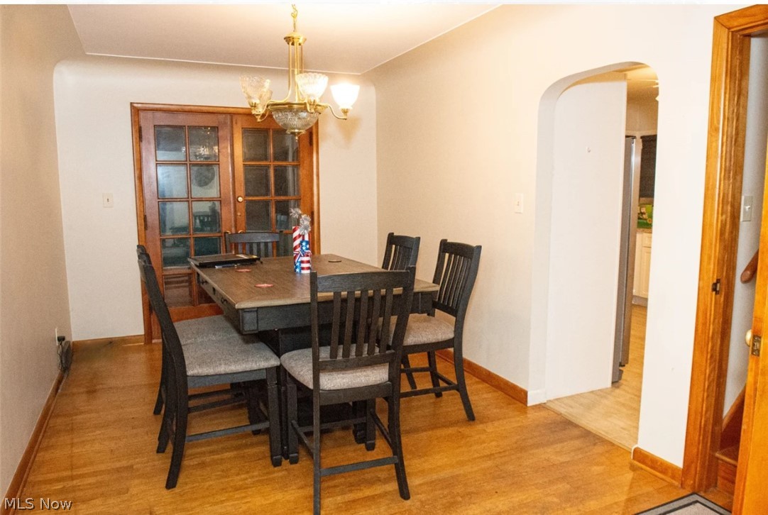 6714 Trenholm Road Youngstown, OH 44512 - Photo 5 of 22 Dining space with an inviting chandelier and light hardwood / wood-style flooring