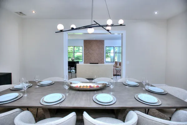 a view of a dining room table and chairs in a room