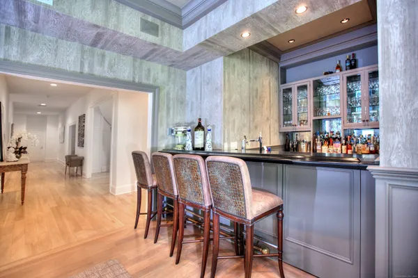 a dining hall with stainless steel appliances a dining table and chairs with wooden floor