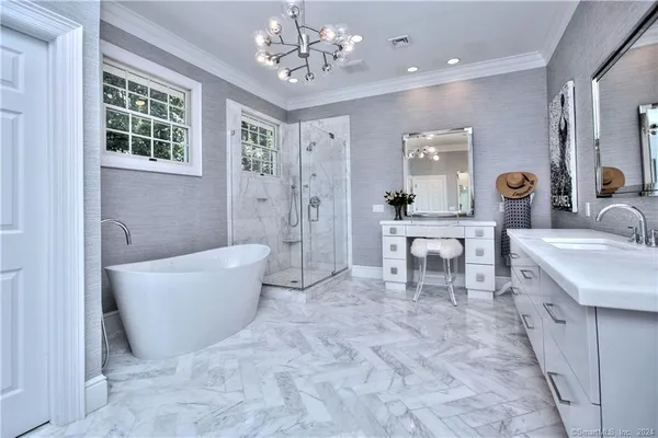 a spacious bathroom with a tub sink and mirror