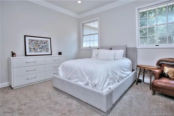 a spacious bedroom with a bed and window