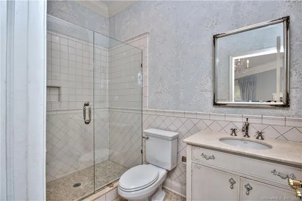 a bathroom with a sink a toilet and shower