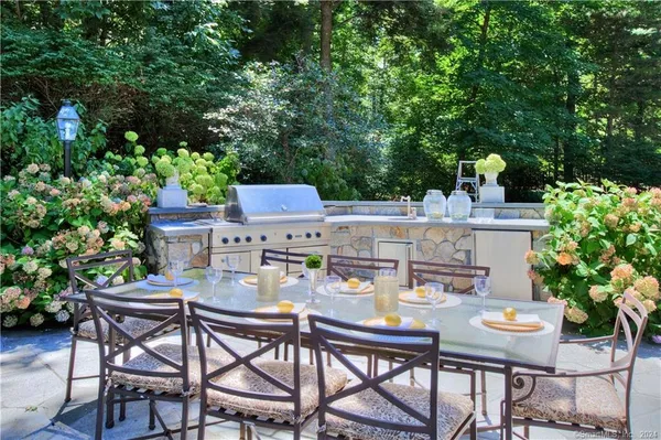 a view of a backyard with furniture and a garden