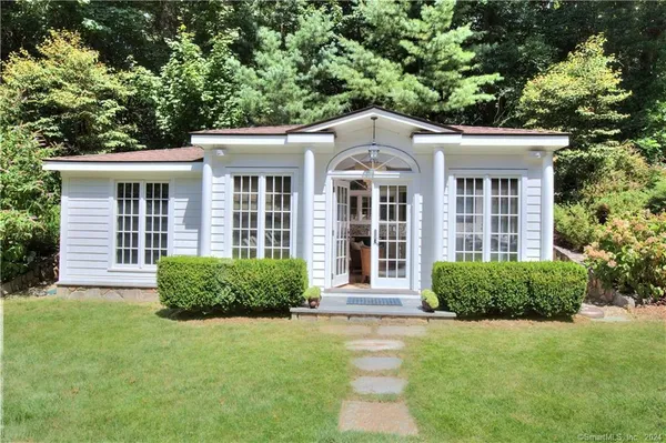 front view of a brick house with a yard