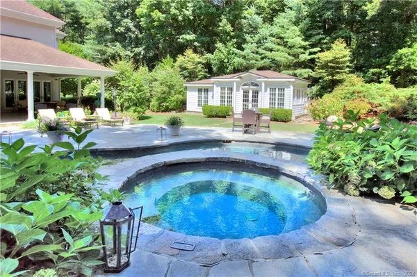 a swimming pool with outdoor seating and garden