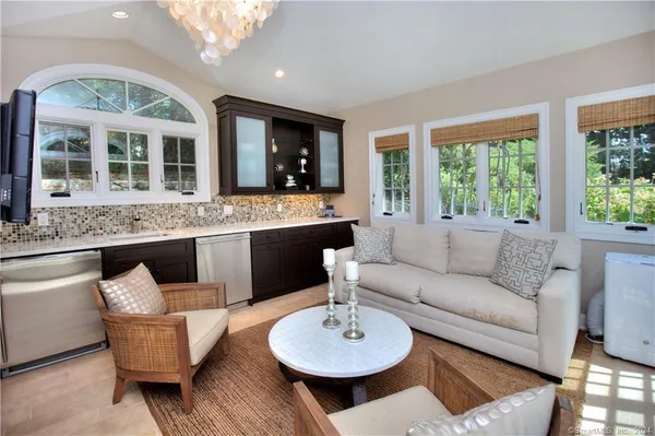 a living room with furniture a large window and a table