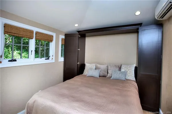 a bedroom with a bed and a large window