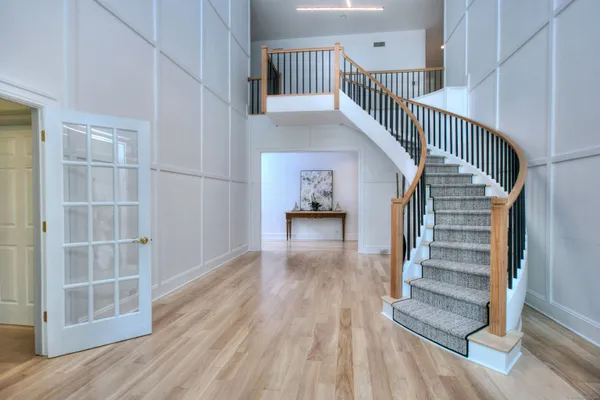 a view of entryway and hall with wooden floor