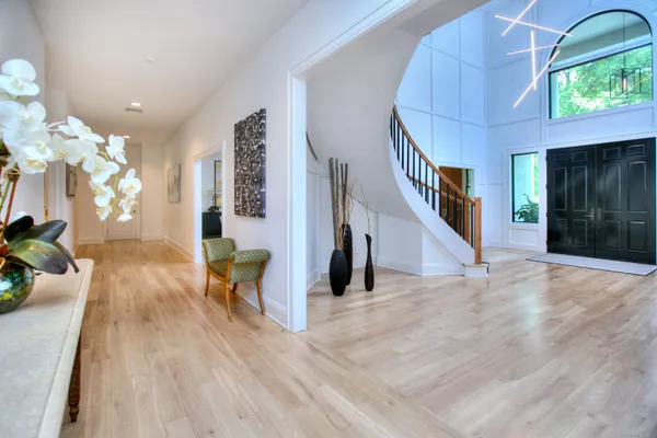 a view of a living room with wooden floor and a chandelier