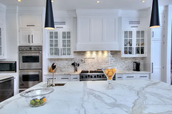 a kitchen with stainless steel appliances a stove a sink and a refrigerator