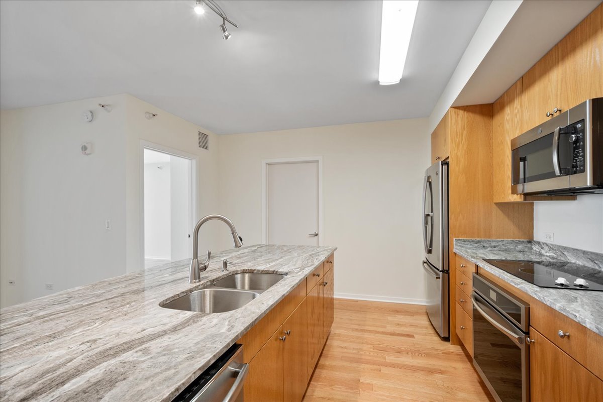 807 Davis Street, Unit 1607 Evanston, IL 60201 - Photo 5 of 28 a kitchen with a sink and a stove top oven