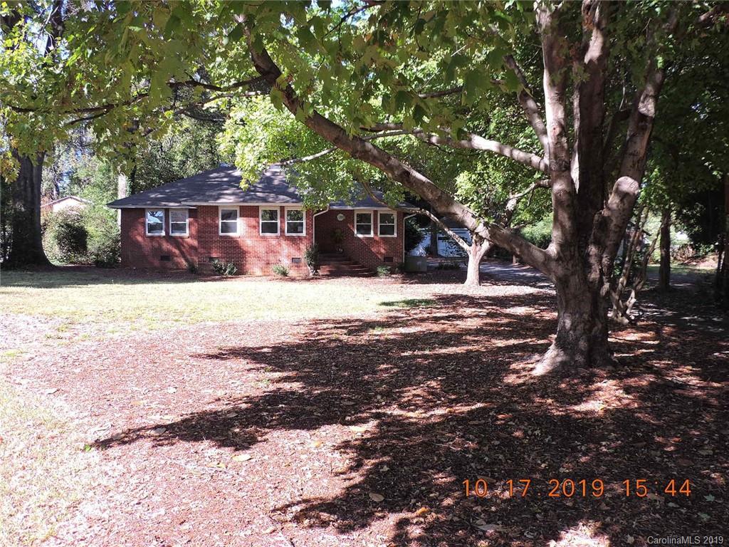 5908 Tuckaseegee Road Charlotte, NC 28208 - Photo 1 of 30 a house with trees in front of it