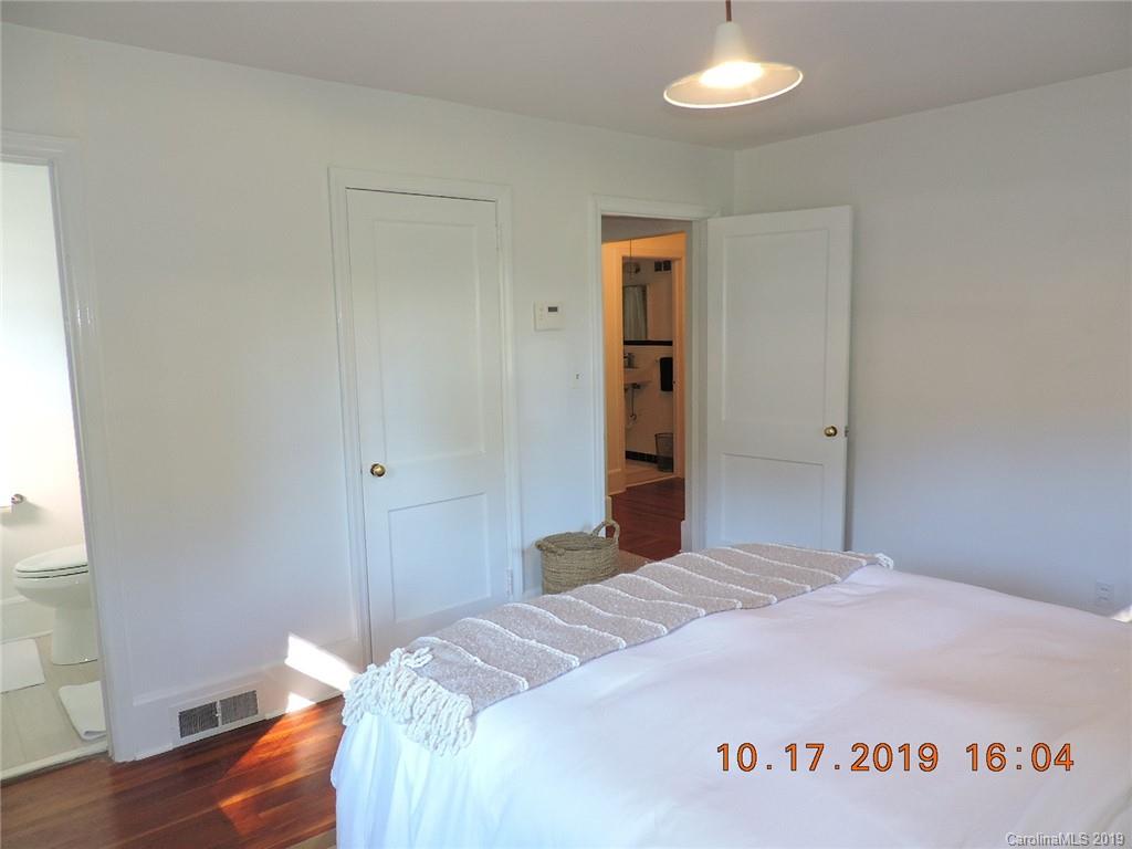 5908 Tuckaseegee Road Charlotte, NC 28208 - Photo 14 of 30 a bedroom with a bed and a potted plant