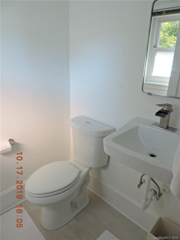 5908 Tuckaseegee Road Charlotte, NC 28208 - Photo 16 of 30 a white toilet sitting next to a bathroom sink
