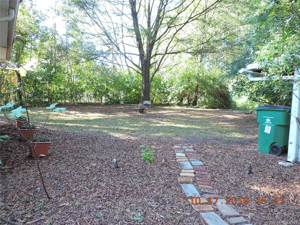 5908 Tuckaseegee Road Charlotte, NC 28208 - Photo 24 of 30 a backyard of a house with lots of green space