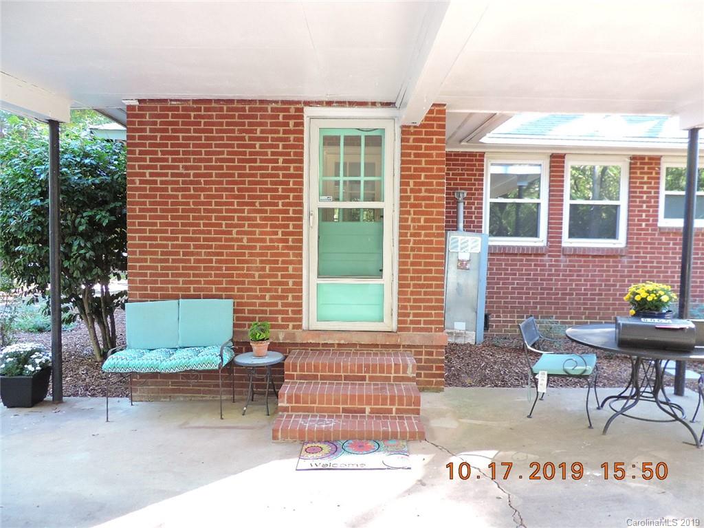 5908 Tuckaseegee Road Charlotte, NC 28208 - Photo 28 of 30 a front view of a house with a garden