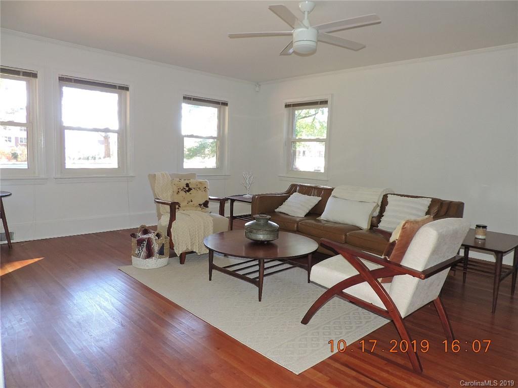 5908 Tuckaseegee Road Charlotte, NC 28208 - Photo 7 of 30 a living room with furniture a window and wooden floor
