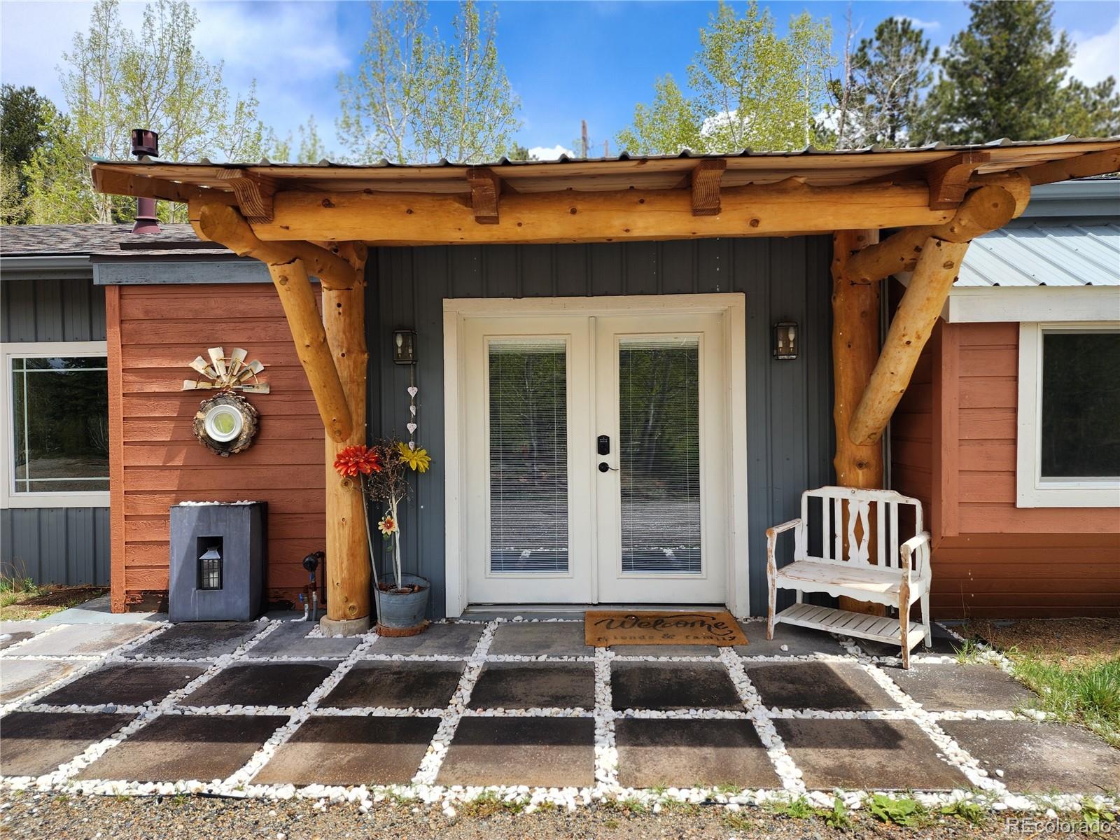 388 Clark Road Bailey, CO 80421 - Photo 7 of 50 a front view of a house with a porch