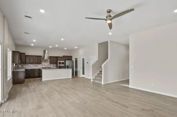 a view of kitchen with stainless steel appliances refrigerator oven and microwave