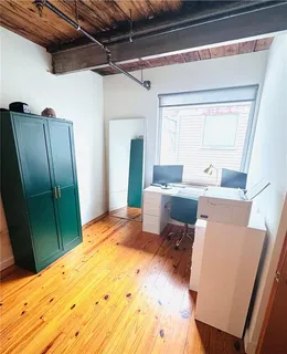 a bedroom with a bed furniture and a large window